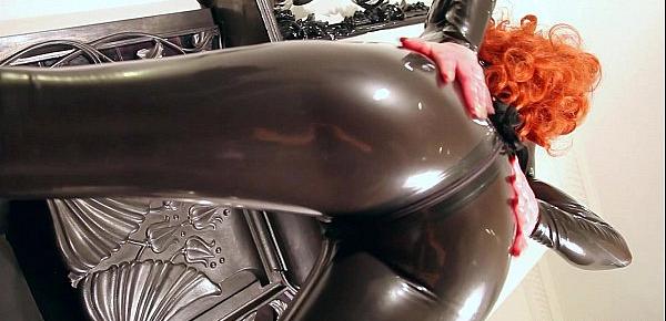 Red lubes up her latex catsuit and rubs her juicy wet pussy